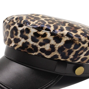 Leopard print newsboy cap in black PU leather and fabric with a stylish gold button detail