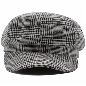 Close-up of black and white houndstooth pattern and wool texture on newsboy cap