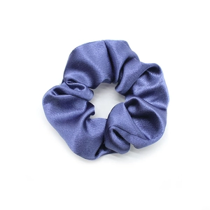 Detailed view of glossy blue satin hair scrunchie with smooth pleated fabric texture