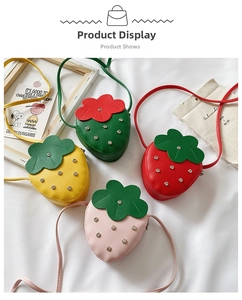 Detail view of strawberry-shaped kids purses with rivet studs in four vibrant colors