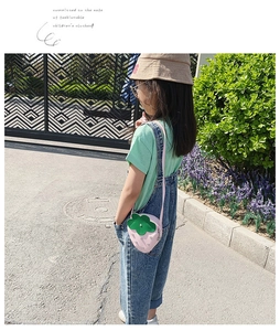 Pink strawberry crossbody bag with silver studs and green leaf detail for children