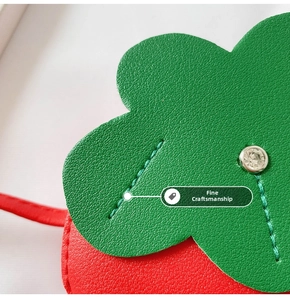 Close-up of strawberry bag detail with lychee leather texture and rhinestone stud