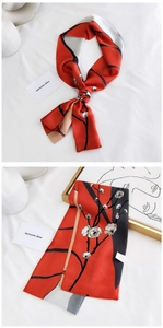 Detail of red silk scarf with white plum blossom print and elegant Chinese style art