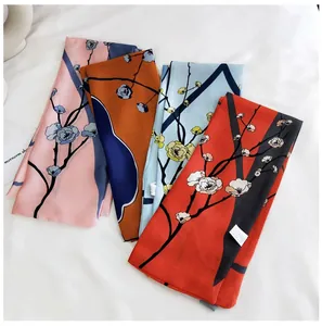 Detailed view of four narrow floral scarves in pink, orange, blue and red plum blossom print