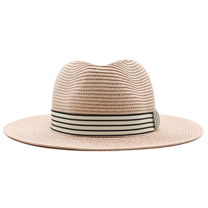 Close-up of fine woven paper straw texture and black-white striped ribbon on fedora hat
