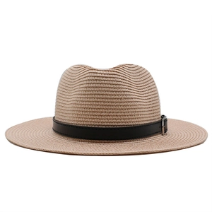 Detail of light brown straw fedora with black leather band and silver buckle