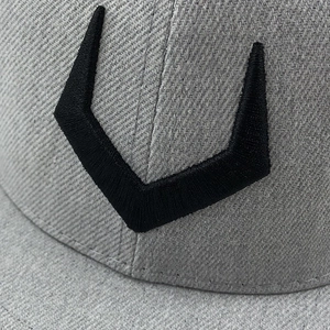 Macro shot of 3D black embroidery on grey flat brim hip hop cap with diagonal twill texture