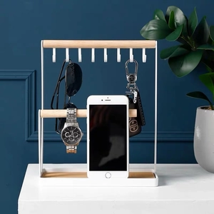 White metal jewelry organizer with wood bar for keys, watches and necklaces on desk