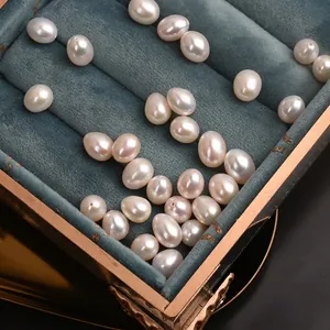 Lustrous 7.5-8mm natural freshwater rice pearls displayed in a navy blue velvet jewelry box