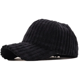 Detailed texture of black corduroy fabric on a stylish autumn-winter baseball cap