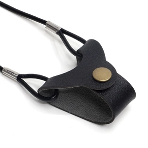 Close-up of black leather eyeglass lanyard with brass snap button and metal ring detail