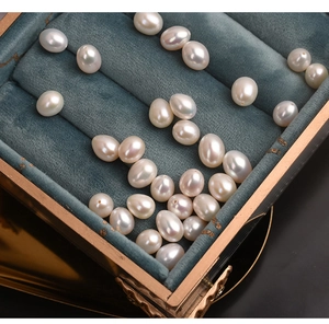 Close-up of 7.5-8mm natural white freshwater pearls in a vintage velvet jewelry box