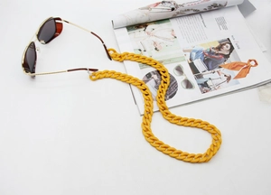 Close-up of chunky bright yellow acrylic glasses chain with adjustable silicone loops
