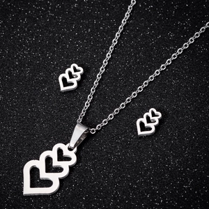 Silver stainless steel jewelry set featuring hollow heart necklace and stud earrings