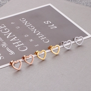 Three pairs of hollow heart stud earrings in rose gold, gold, and silver finishes
