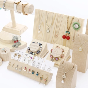 Solid wood jewelry display stand set for earrings, necklaces and rings on white backdrop