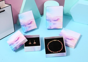 Detail of pink-purple gradient jewelry boxes with premium soft cloud textures