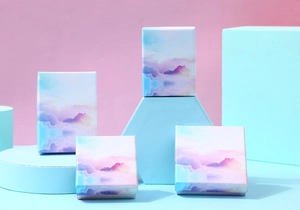 Artistic jewelry gift boxes with pastel cloud design on geometric display stands