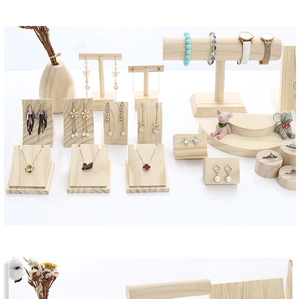 Macro detail of solid wood jewelry display stands including necklace and ring holders