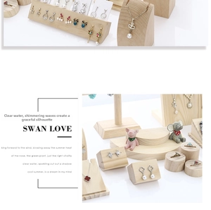 Macro detail of solid wood jewelry display stand with alloy earrings and necklaces