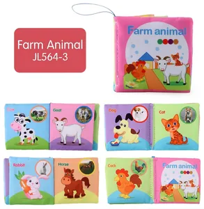 Detail of farm animal soft cloth book featuring cow and goat illustrations for baby learning