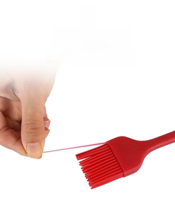 Detail showing the high-toughness red silicone bristles being pulled to test flexibility