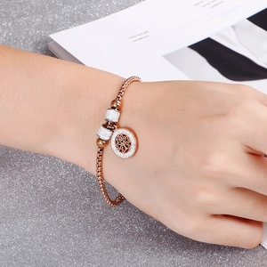 Rose gold tree of life bracelet with sparkling crystals on a woman's wrist