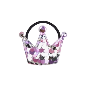 Detail showing glittery pink and purple sequin crown hair tie on a plain white background