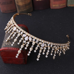 Detail of gold bridal crown with pear-shaped rhinestones and dangling fringe accents