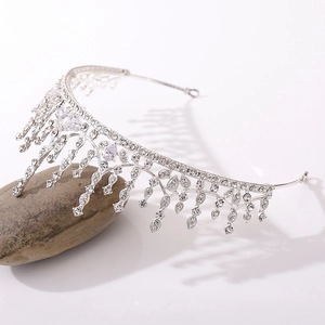 Detail view of silver bridal tiara with tassel rhinestones on a textured stone base