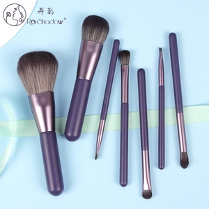 Detail of 7-piece purple makeup brush set with matte handles and soft synthetic bristles