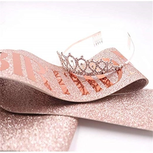 Macro detail of rose gold glitter birthday sash and sparkling crystal tiara crown