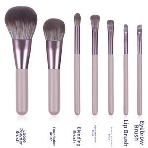 Detailed set of 7 professional purple makeup brushes with soft gradient synthetic bristles