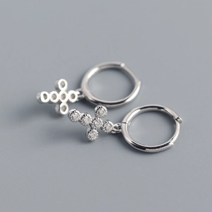 Macro shot of S925 sterling silver mini cross hoop earrings with sparkling cubic zirconia