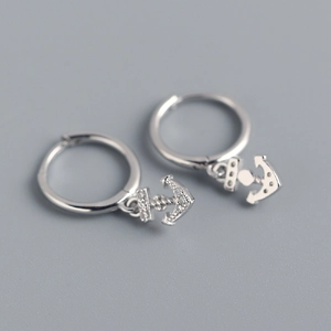 Detailed macro view of S925 sterling silver anchor earrings with sparkling crystals