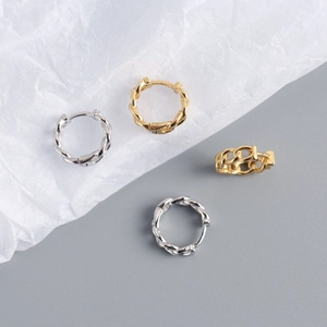 Detailed view of gold and silver S925 sterling silver chain and twist hoop earrings