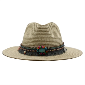 Detail of straw fedora hat featuring ethnic beaded band, turquoise stone, and fringe