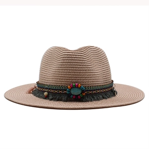 Detail view of straw fedora hat featuring bohemian beads, turquoise and gray tassels