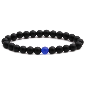 Matte black onyx beaded bracelet featuring a single blue lapis lazuli accent bead