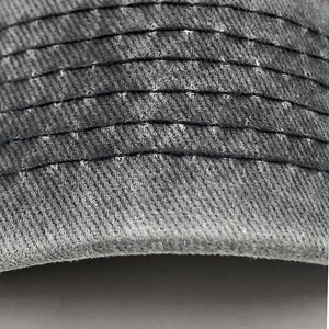 Close-up of the detailed parallel stitching on a washed grey cotton baseball cap brim