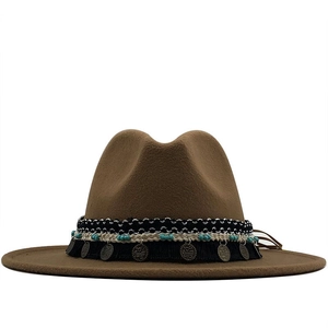 Detail of bohemian fedora hat with ethnic woven band and turquoise beaded charms