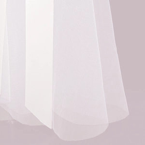 Close-up of white bridal tulle fabric with satin ribbon edge and soft texture