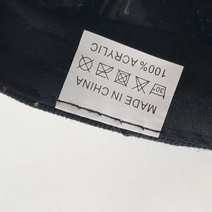 Detail view of product washing label showing 100% acrylic material and made in China text