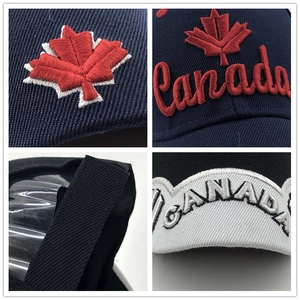 Detail of embroidered Canada maple leaf and letter text on contrast baseball cap
