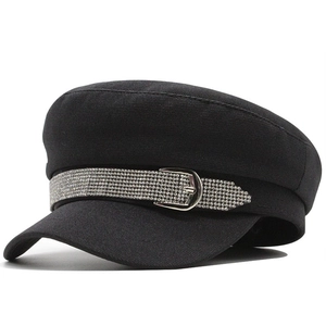 Detailansicht der schwarzen Schirmmütze mit Strass-Gürtelschnalle und Twill-Stoffstruktur