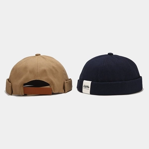 Retro brimless dockers caps in khaki and navy blue with adjustable leather back straps