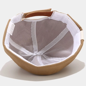 Detail view of khaki cotton docker cap interior showing premium stitching and leather strap