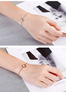 Detail of adjustable silver and rose gold teardrop bracelets with pavé-set stones