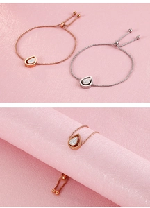 Detail view of adjustable teardrop zircon bracelets in rose gold and silver finishes