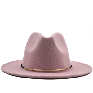 Pink wool fedora hat with a thin gold metal band and classic stylish jazz crown